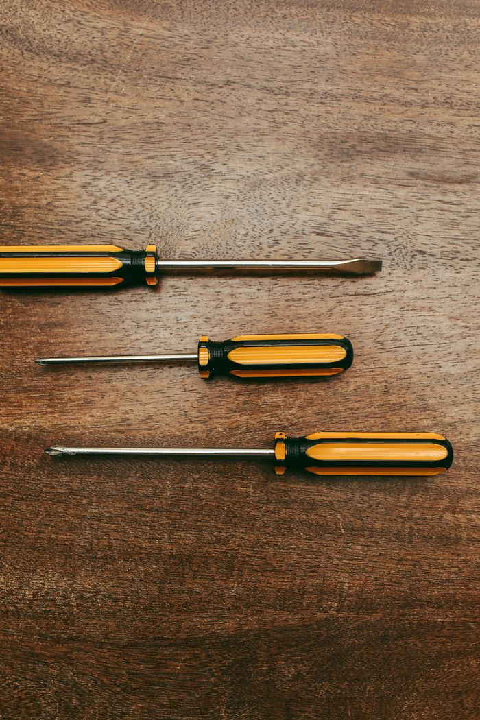 The Art of Drawing Readers In: Your attractive post title goes here Close-up of three screwdrivers on a wooden surface, showcasing tool diversity.